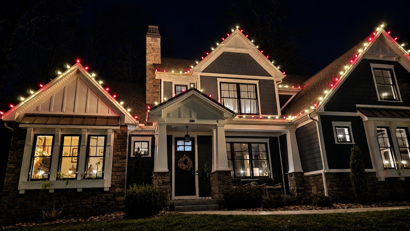 Red and warm-white C9 Christmas lights outlining a detailed home in Harrisburg, Pennsylvania