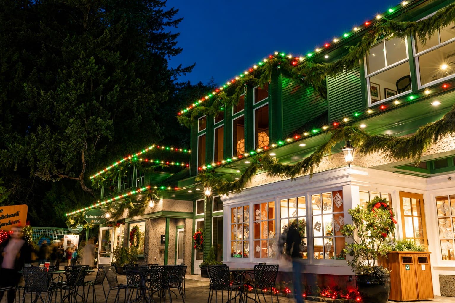 Red, green, and warm-white commercial roofline lighting with evergreen garland in Lancaster, Pennsylvania