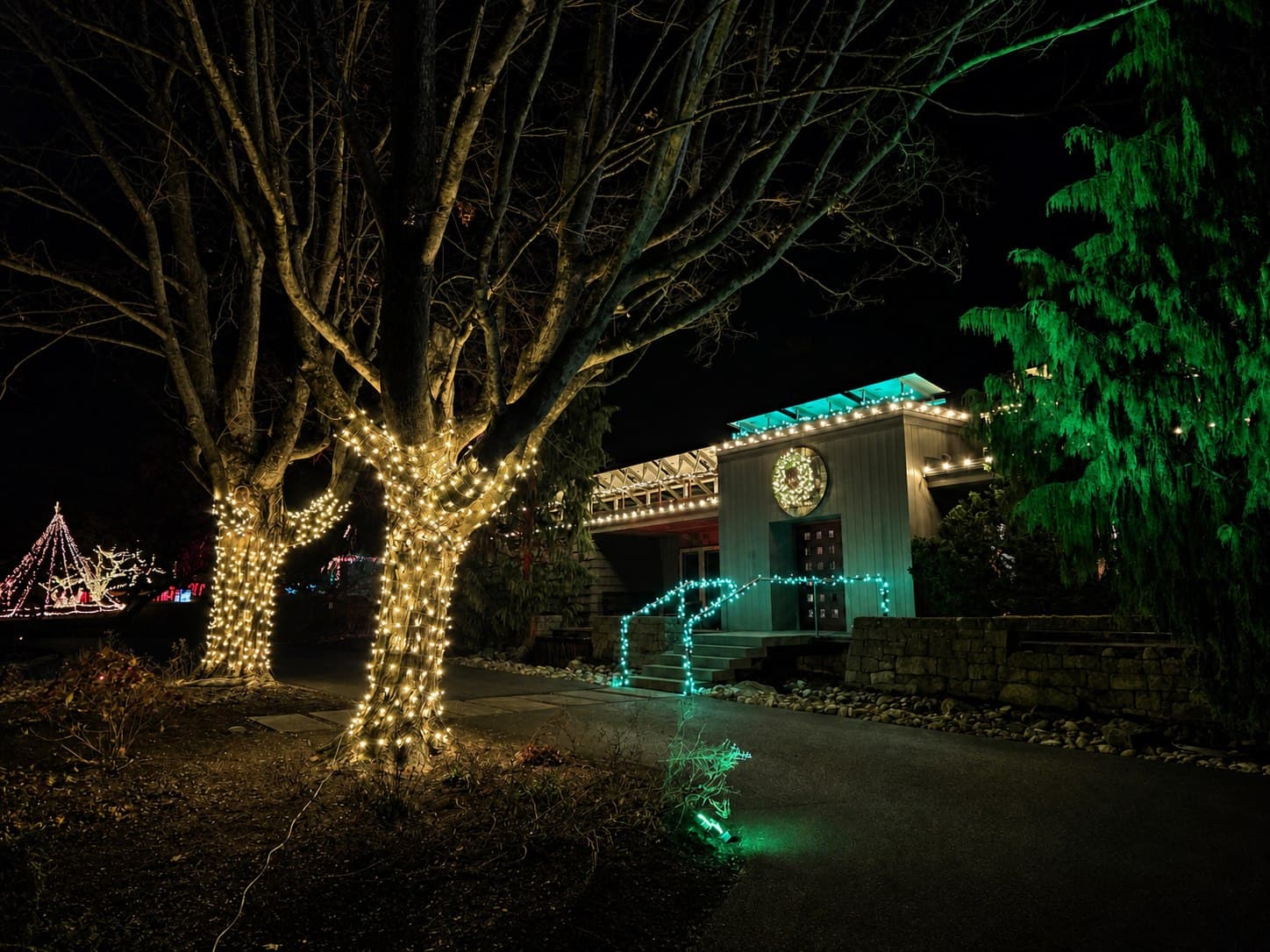 Warm-white tree wraps and teal entrance lighting at a commercial property in Lebanon, Pennsylvania